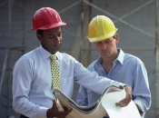 Men Looking At Plans